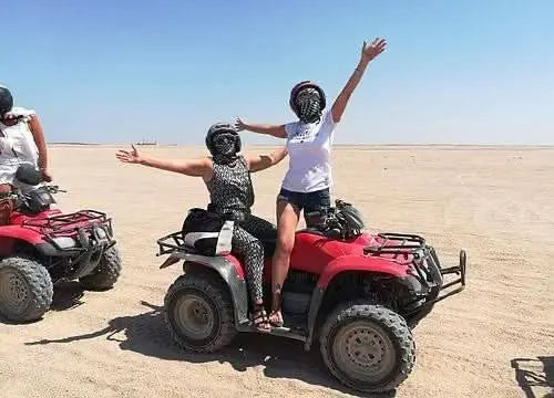 You can see 2 ladies on a red quad bike