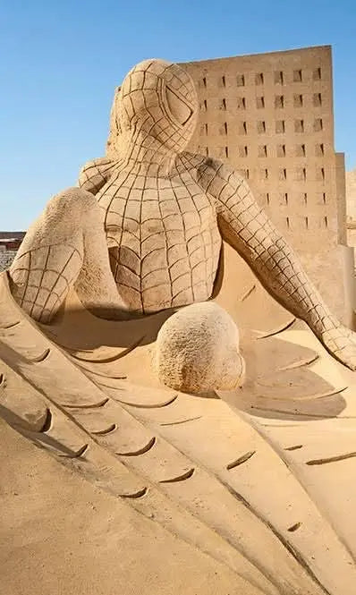 Sand sculpture of a man at Sand City Museum, showcasing mythological art and creativity in an outdoor setting.