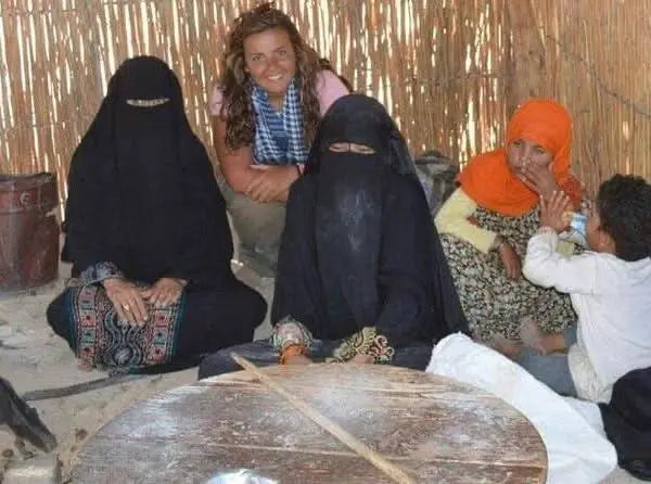 Group of women in a circle, illustrating the 3 hour safari with quad bike and camel ride, emphasizing cultural exploration and adventure in the desert.
