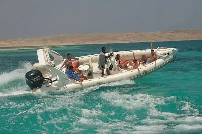 Group on a boat heading to Orange Bay Island via private speedboat, offering a personalized Red Sea adventure with snorkeling and beach relaxation options.