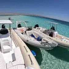 Inflatable boats on water, showcasing the Orange Bay island with private speedboat experience, highlighting adventure and relaxation on the scenic Red Sea journey.