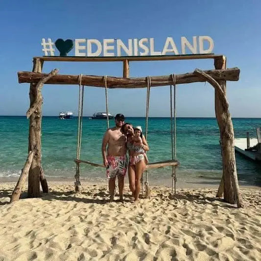 Group enjoying a beach swing during the Eden Island Tour, highlighting the vibrant outdoor setting and excitement of the Red Sea adventure.