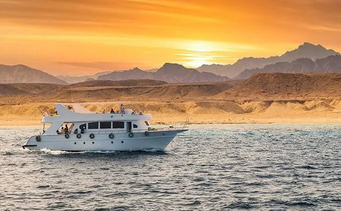 An excursion boat on the sea at sunset