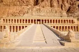 Guided tour to Luxor with overnight stay, featuring a historic walkway leading to an ancient Egyptian temple, reflecting Luxor's rich archaeological heritage.