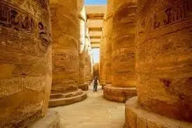 Luxor day tour package showcasing ancient pillars, includes temple visits, Nile boat ride, and historic site exploration with overnight stay.