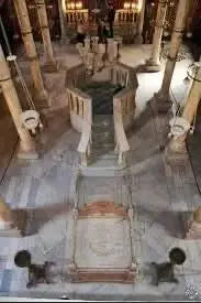 Stone structure with columns depicting ancient architecture, illustrating the cultural tour to Cairo's historic sites, including the Pyramids of Giza and the Egyptian Museum.