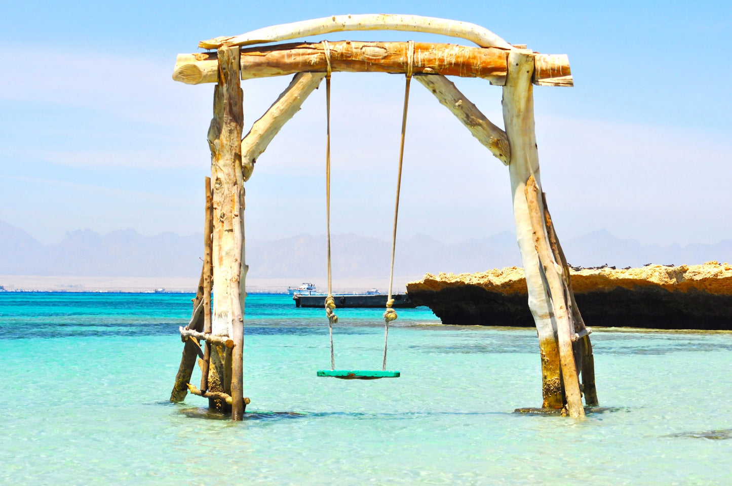 Swing over water at Orange Bay Tour, showcasing adventure and relaxation in Hurghada's pristine coastal paradise, featuring snorkeling, sandy beaches, and thrilling water sports.