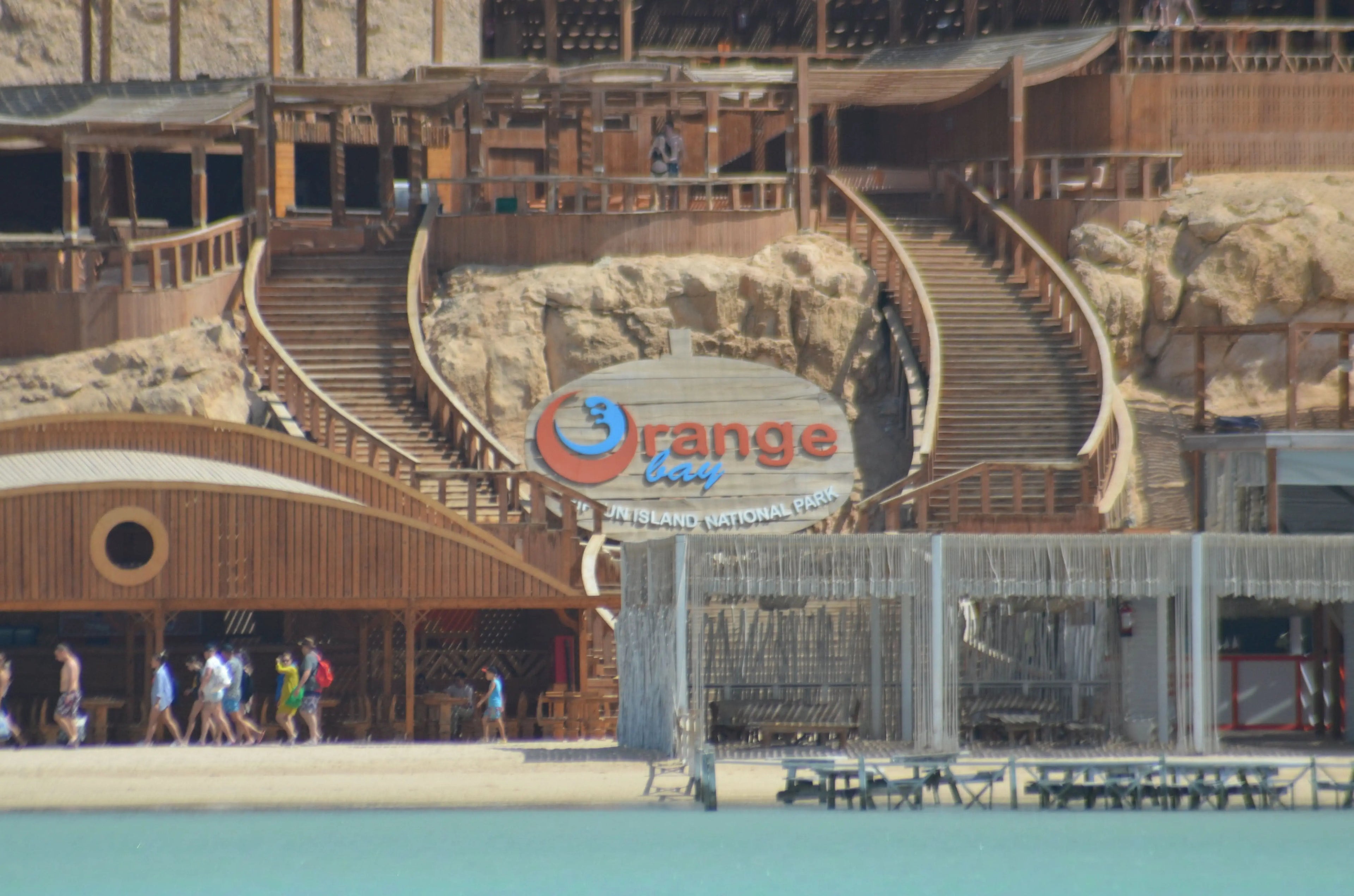 Orange Bay Tour: Image of a large building with stairs, people walking nearby, representing the starting point for an adventure-filled day in Hurghada.