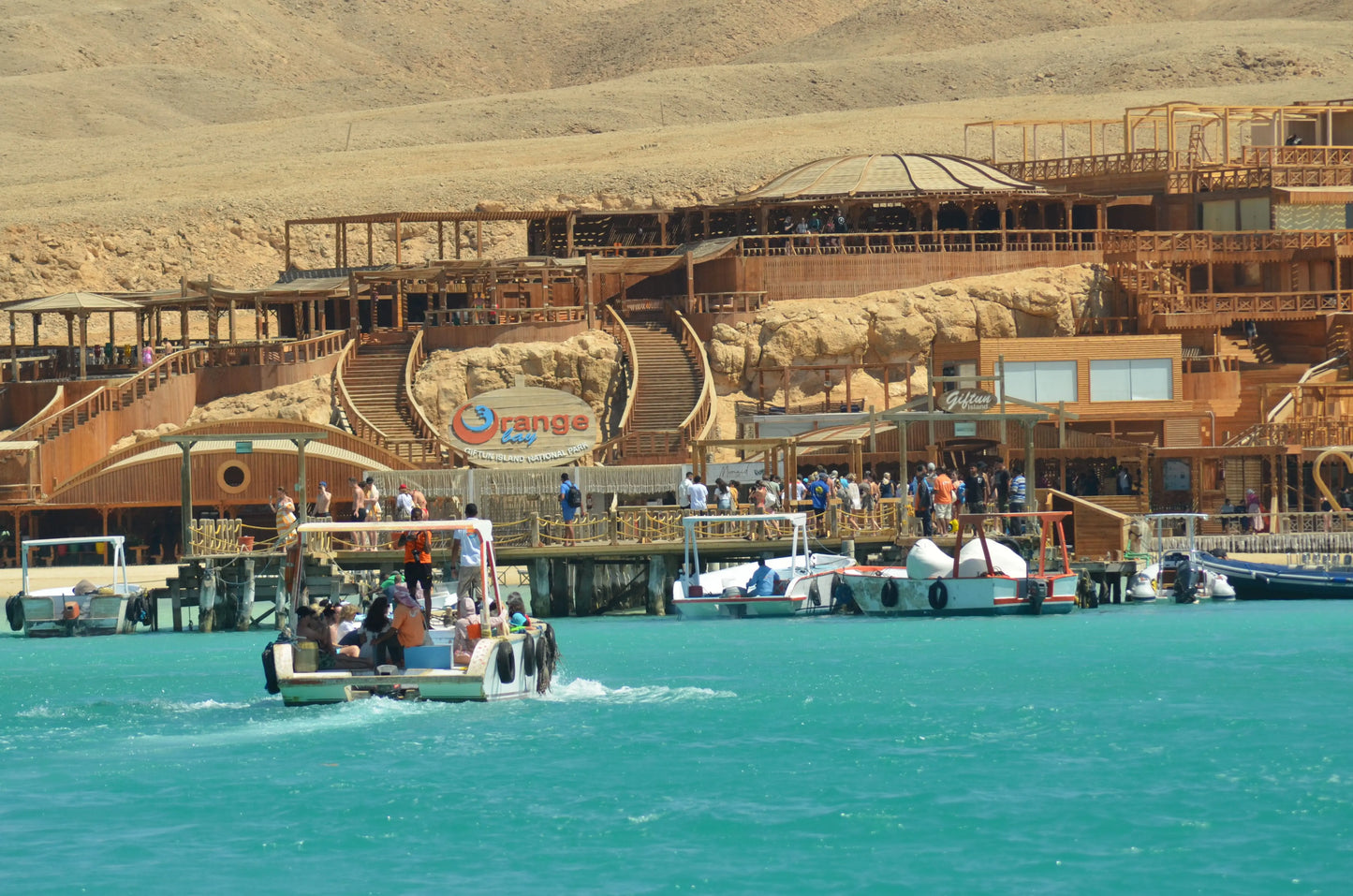 People enjoying the Orange Bay Tour on a boat, preparing for snorkeling and exploring the beautiful coral reefs and beaches in Hurghada.