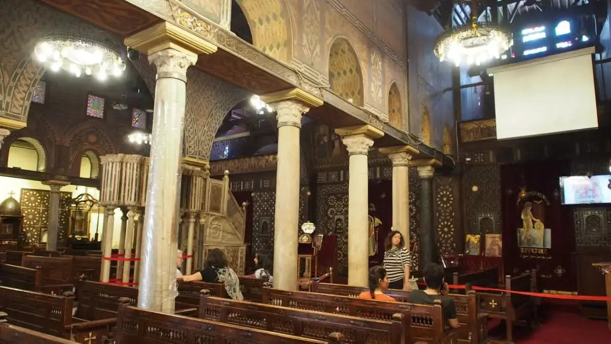 People gather inside a church, highlighting the cultural tour vibe of the Cultural Tour to Cairo - 1 day experience, emphasizing historical exploration.