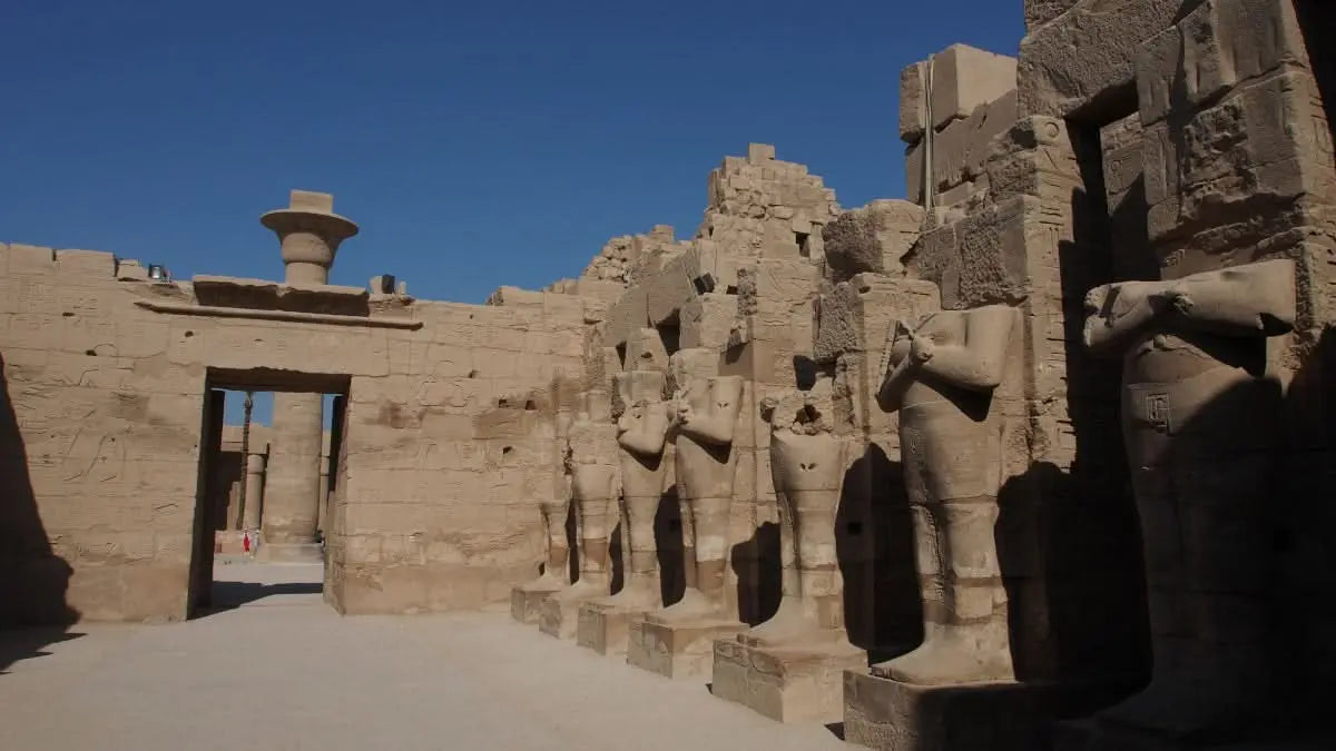 Luxor day tour package: Explore ancient stone statues at Karnak Temple, including an overnight stay, capturing the essence of Egypt's historical grandeur.