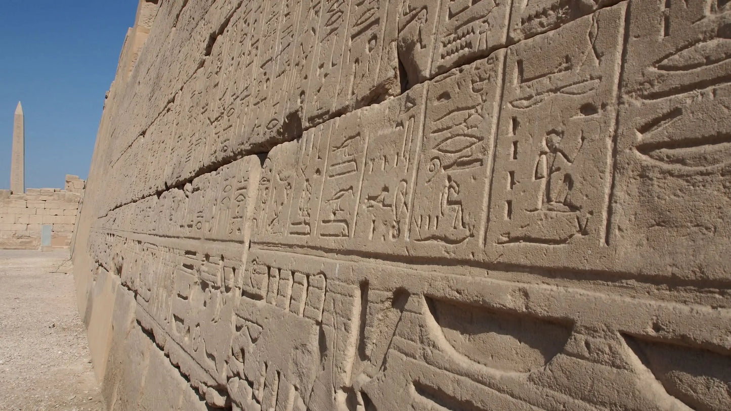 Stone wall with hieroglyphics, representing the day tour to Luxor incl. overnight stay, showcasing ancient Egyptian history and monumental sites like Karnak Temple and Valley of the Kings.