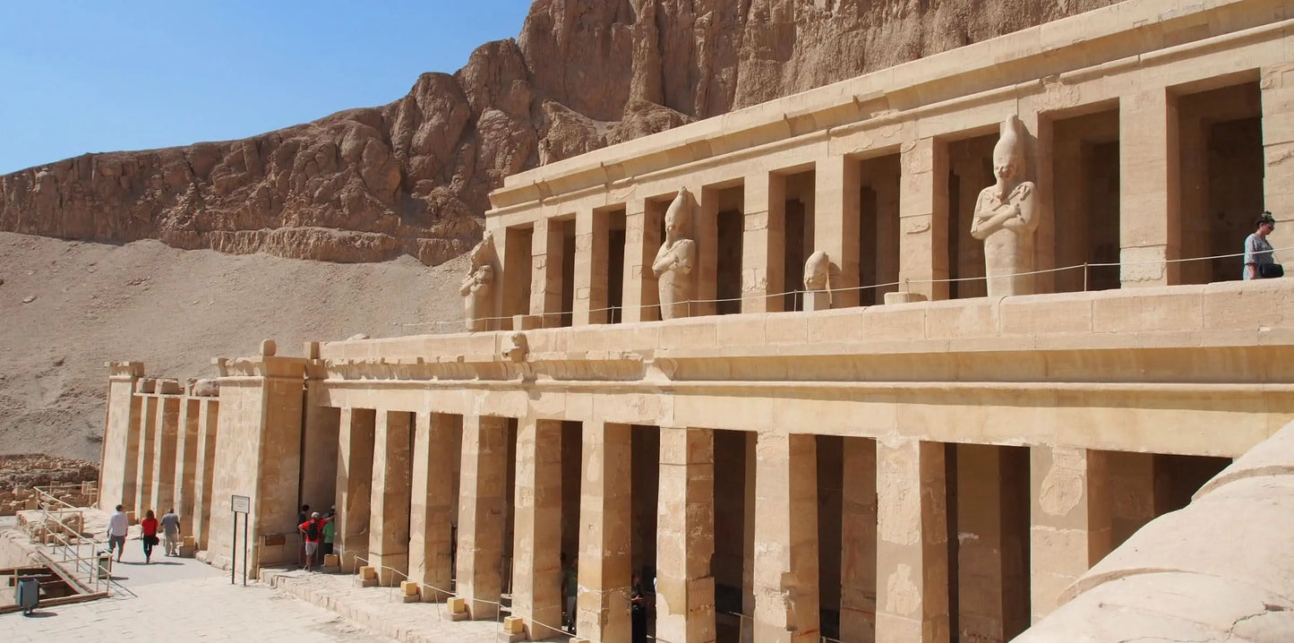 Luxor day tour with overnight stay, featuring ancient stone buildings and statues, highlighting Karnak Temple and other historic sites.