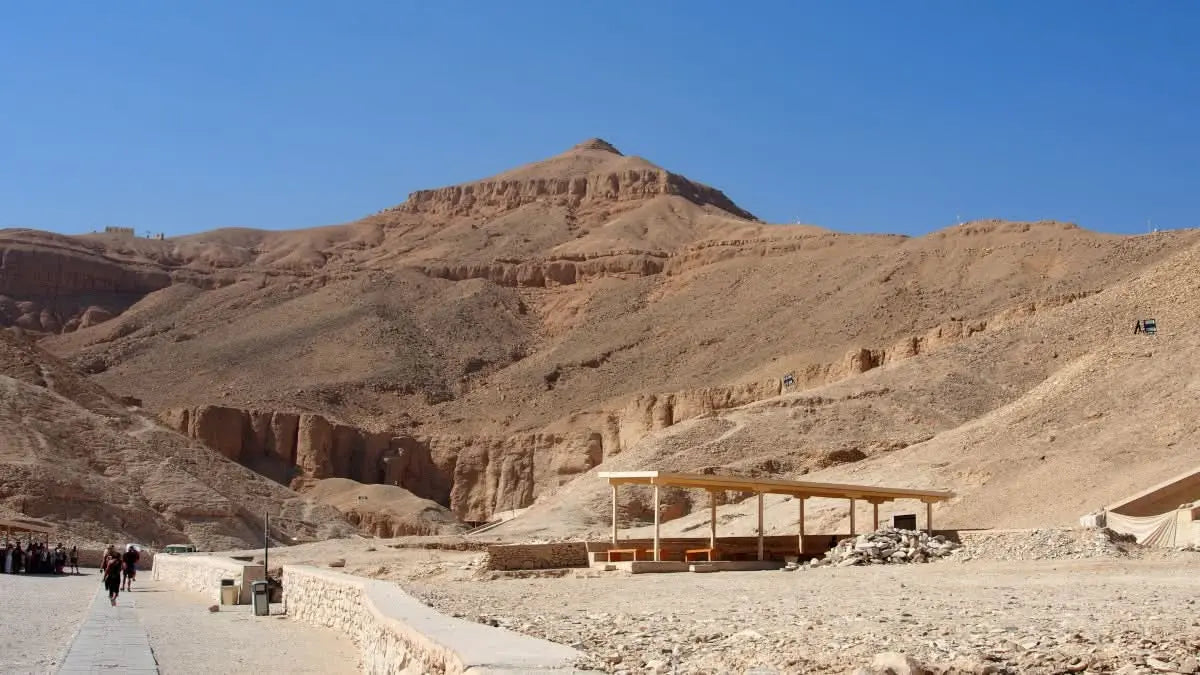 Luxor day tour featuring desert landscape, wooden structure, and ancient temples, highlighting the Karnak Temple and Nile boat trip. Experience Egypt's history and culture.