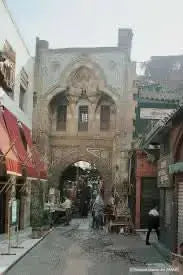 Stone archway in a city street, representing the cultural exploration of the Cultural tour to Cairo - 1 day to ancient Egyptian sites.