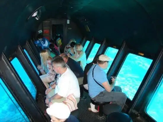 People enjoying the Sindbad Submarine Tour on a boat, experiencing an underwater adventure to view coral and marine life without diving in Hurghada.