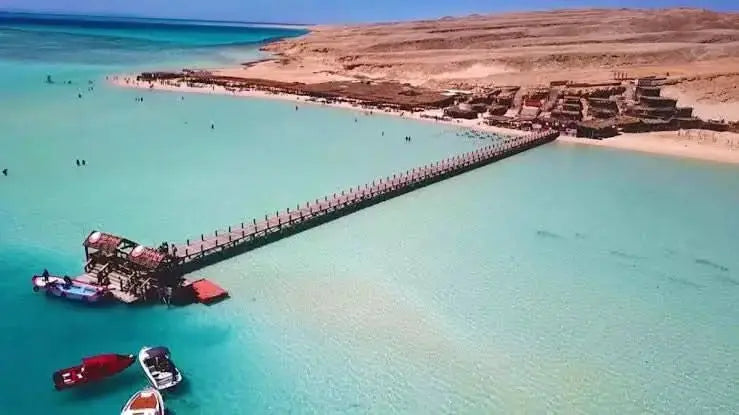 Paradise Island tour: A long dock extending over clear blue water, highlighting the starting point for a private speedboat and snorkeling adventure.