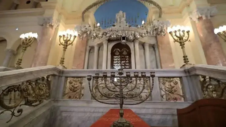 Large metal candlestick in a stone-railed room, reflecting cultural ambiance, part of the Cultural Tour to Cairo - 1 day experience.