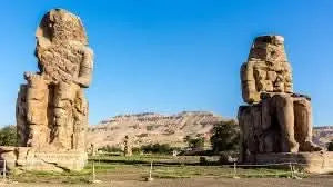 Luxor day tour product image featuring ancient stone statues and ruins against a clear sky, highlighting the historical and cultural essence of the excursion.