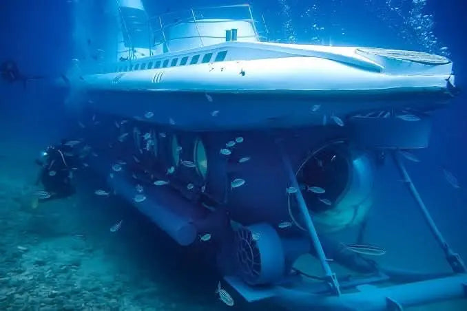 Sindbad Submarine Tour showcasing a submarine underwater surrounded by fish, offering a unique Red Sea adventure exploring vibrant marine life comfortably.