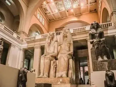 Statues in a museum setting, reflecting Egyptian cultural history, align with the Cultural Tour to Cairo - 1 day experience, emphasizing ancient art exploration.