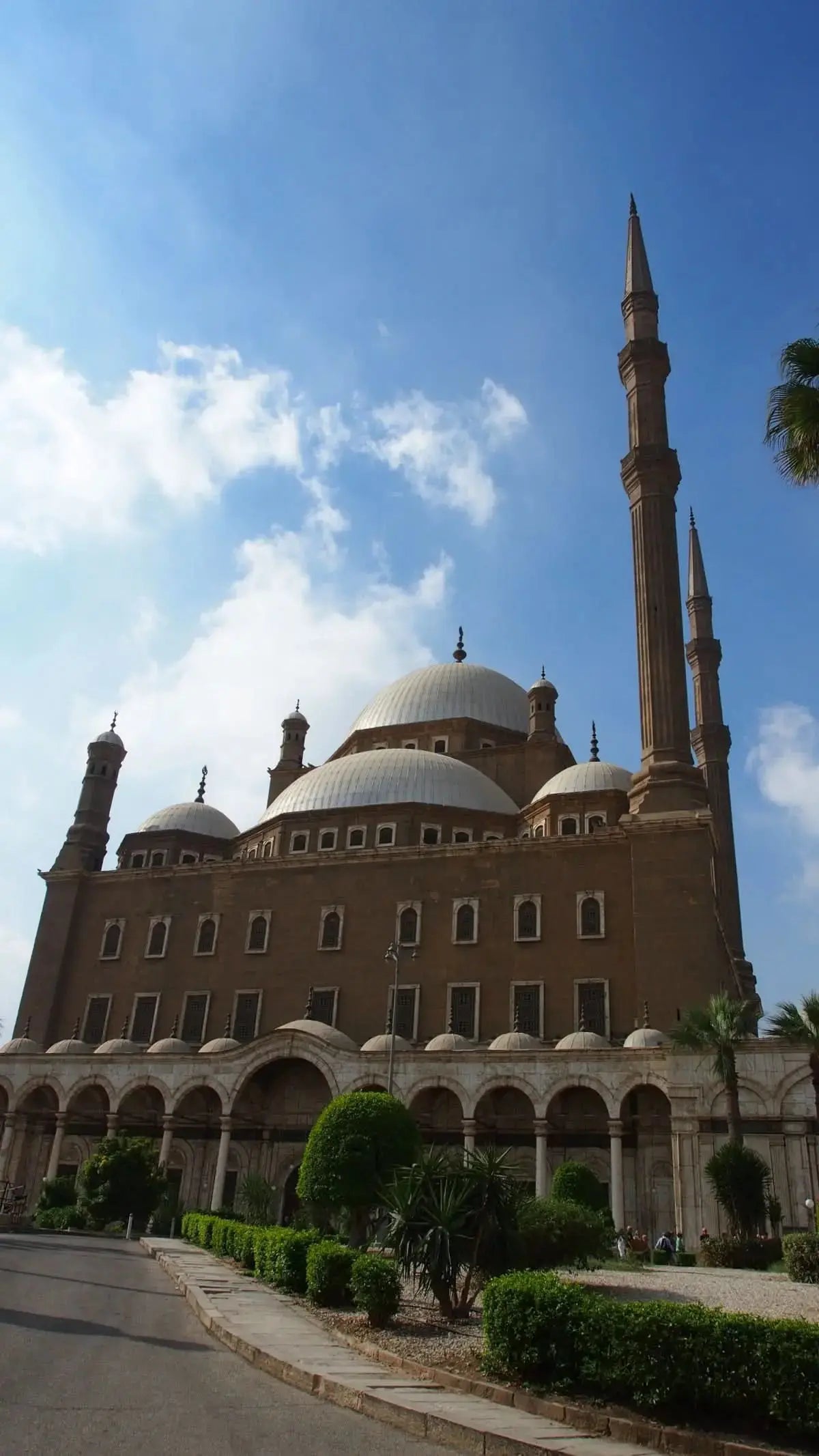 Historic building with a tall tower and dome, representing the cultural tour to Cairo, highlighting the exploration of Egypt's iconic landmarks like the Pyramids of Giza.