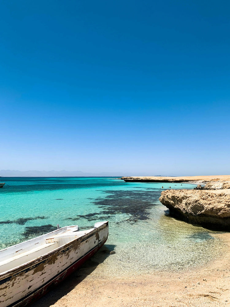 A sandy beach and the blue sea in the background