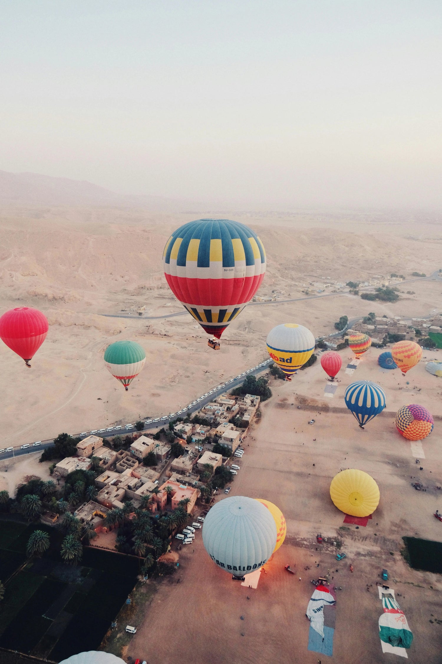 You can see several hot air balloons following the course of the river in a desert