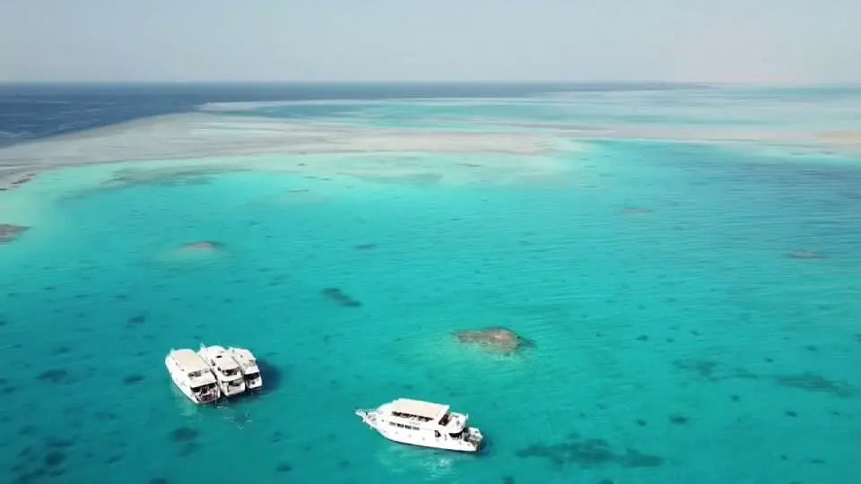Paradise Island with private speedboat and snorkeling tour showcasing boats in clear turquoise water, highlighting an adventurous and customizable island experience.