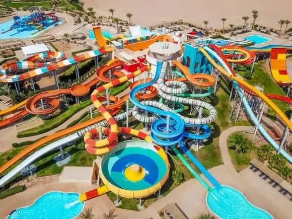 Jaz Makadi Aquaviva Waterworld with colorful slides and large pools, offering diverse water activities for all ages in Hurghada's largest water-themed park.