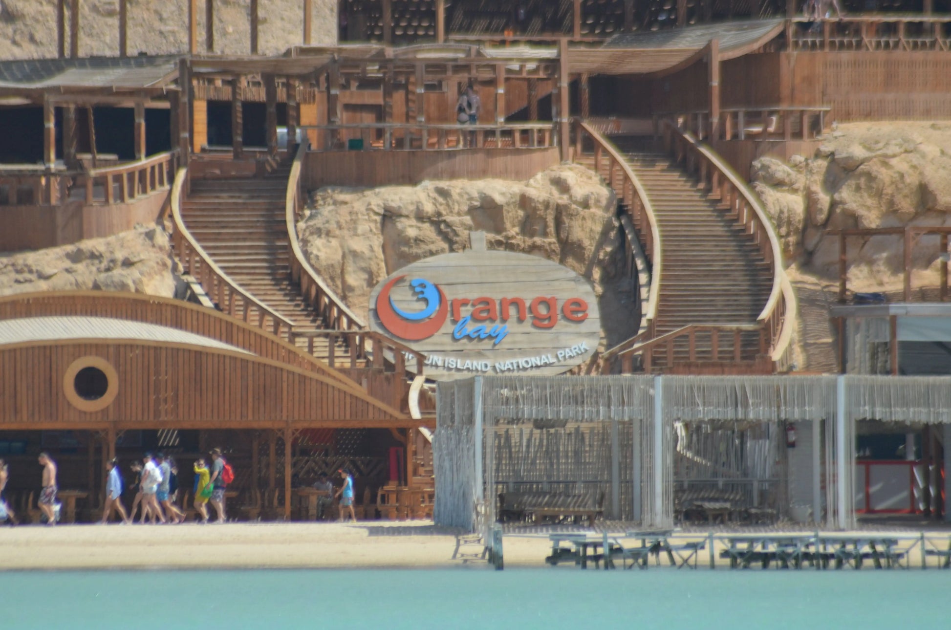 Orange Bay Tour: Image of a large building with stairs, people walking nearby, representing the starting point for an adventure-filled day in Hurghada.