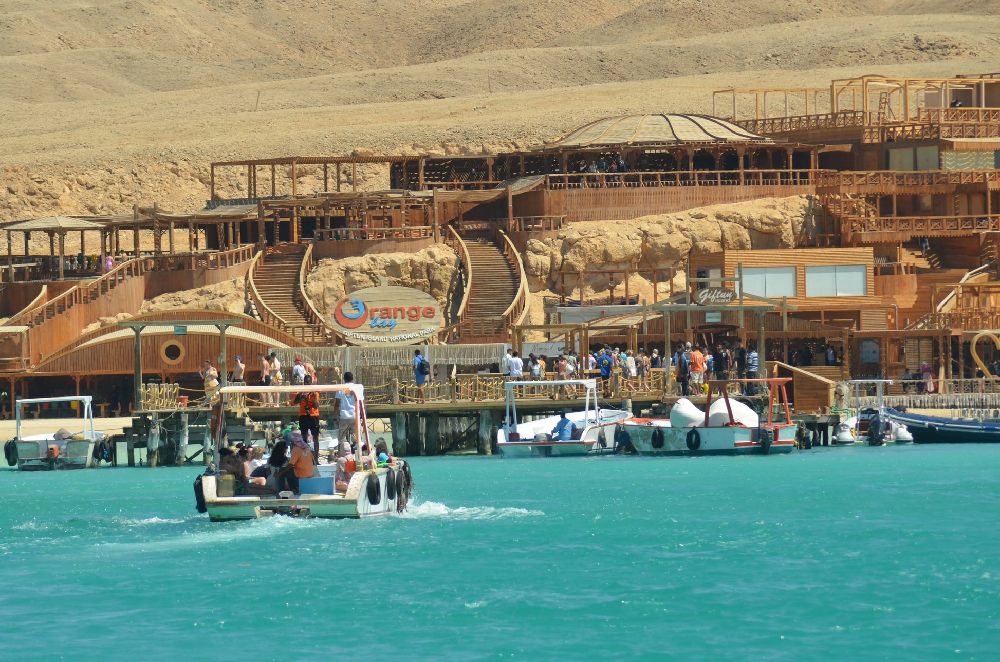 People enjoying the Orange Bay Tour on a boat, preparing for snorkeling and exploring the beautiful coral reefs and beaches in Hurghada.