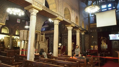 People gather inside a church, highlighting the cultural tour vibe of the Cultural Tour to Cairo - 1 day experience, emphasizing historical exploration.