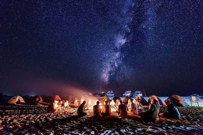 People enjoying a campfire under a starry sky during the jeep safari with stargazing, highlighting the adventure's blend of nature and astronomy experiences.