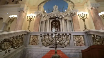 Large metal candlestick in a stone-railed room, reflecting cultural ambiance, part of the Cultural Tour to Cairo - 1 day experience.